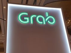 A Grab logo is pictured at the Money 20/20 Asia Fintech Trade Show in Singapore