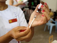 A nurse prepares a measles-rubella vaccine in Yangon