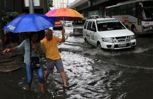 Filipinos wading in the flood