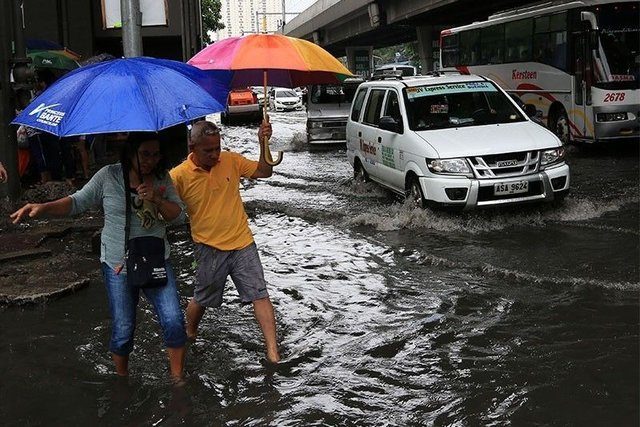 Filipinos wading in the flood