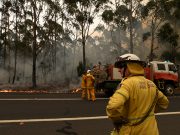 Rural Fire Service volunteers and Fire and Rescue NSW officers contain a small bushfire which closed the Princes Highway south of Ulladulla