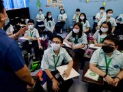 Students wear masks amid a health scare over a new virus that has infected thousands since emerging in China, in a Chinese school in Quezon City