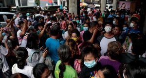 A long queue is formed outside a medical supply store that sells face masks, a day after Philippine government confirmed first novel coronavirus case, in Manila, Philippines