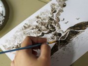 Filipina artist Janina Sanico paints an image of Taal volcano