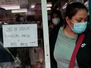 A sign is posted on a medical supply store that says surgical and N95 masks are already out of stock, in Manila,