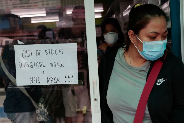 A sign is posted on a medical supply store that says surgical and N95 masks are already out of stock, in Manila,