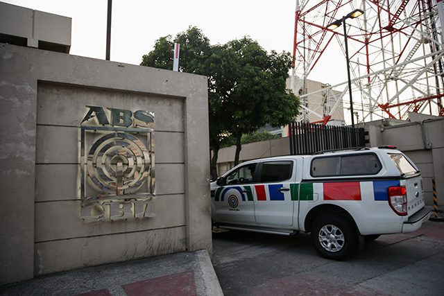 A media crew cab enters the ABS-CBN Broadcasting Center, the office of the country's top broadcast network, following a move by the Philippine government to scrap its franchises, in Quezon City