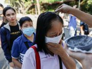 Filipino Catholics wearing protective masks receive ash on top of their heads as the church observes a "contactless" Ash Wednesday amid coronavirus scare, at the National Shrine of Our Mother of Perpetual Help, Paranaque City
