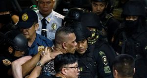 Archie Paray, the gunman and former security guard who took dozens hostage inside a mall, is arrested by police in San Juan, Metro Manila