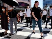 As COVID-19 cases surge, Japan sticks to ‘lockdown-lite’ Commuters in Japan