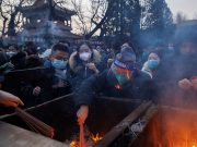 Chinese pray for health in Lunar New Year as COVID death toll rises