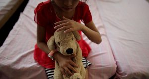 Child with stuffed toy_UNICEF