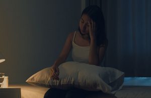 Woman sitting on bed