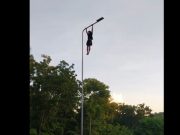 Gym closed? Fitness fanatic does pull-ups on Cebu street lamppost