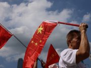 China holds National Day ceremony in waters off atoll claimed by Philippines