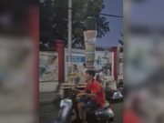 Motorcycle rider turns heads with balancing act of plastic boxes